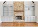 Close-up of a stone fireplace with built-in shelves at 11180 West Rd, Roswell, GA 30075