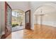 Entry foyer showcasing arched doorway, chandelier, hardwood floors, and decorative iron front doors at 11180 West Rd, Roswell, GA 30075