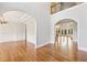 Spacious foyer with arched doorways, hardwood floors, and views to the living spaces at 11180 West Rd, Roswell, GA 30075