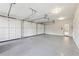 Spacious three car garage features clean epoxy flooring and lots of storage at 11180 West Rd, Roswell, GA 30075