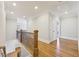 Upstairs hallway featuring wood flooring, wainscoting, and an iron railing at 11180 West Rd, Roswell, GA 30075