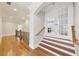 Hallway with hardwood floors that leads to stairs and a doorway with glass doors at 11180 West Rd, Roswell, GA 30075