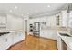 Spacious kitchen featuring stainless steel appliances, a large center island, and custom white cabinetry at 11180 West Rd, Roswell, GA 30075