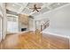 Open concept living room features hardwood floors, stone fireplace, high ceilings, and custom built-in shelving at 11180 West Rd, Roswell, GA 30075