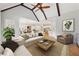 Open concept living room with vaulted ceiling, exposed beams, and hardwood floors at 11180 West Rd, Roswell, GA 30075