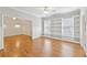 Inviting living room features beautiful hardwood floors and custom built-in shelving at 11180 West Rd, Roswell, GA 30075