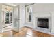 Living room features a fireplace, hardwood floors, and french doors at 11180 West Rd, Roswell, GA 30075
