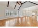 Living room has a cathedral ceiling, exposed beams, and a ceiling fan at 11180 West Rd, Roswell, GA 30075