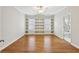 Bright living room with hardwood floors, built-in shelves, and neutral paint at 11180 West Rd, Roswell, GA 30075