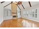 Living room has a stone fireplace, ceiling fan, and built in shelves at 11180 West Rd, Roswell, GA 30075