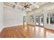 Bright living room with hardwood floors, coffered ceilings, and multiple windows and doors leading to the outside at 11180 West Rd, Roswell, GA 30075