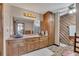 Well-lit bathroom with dual sinks, wood cabinets, tiled floors, and a separate shower area at 2731 Tritt Springs Ne Dr, Marietta, GA 30062