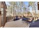 View of the home's outdoor deck area with table, chairs, and grill at 2731 Tritt Springs Ne Dr, Marietta, GA 30062
