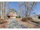 Exterior view of a multi-story house with a driveway and mature trees around the property at 2731 Tritt Springs Ne Dr, Marietta, GA 30062