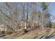 Secluded home exterior behind mature trees, featuring multi-level decks and neutral siding for a private, natural setting at 2731 Tritt Springs Ne Dr, Marietta, GA 30062