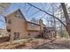 Exterior view of the house featuring a backyard deck with stairs, landscaping, and mature trees at 2731 Tritt Springs Ne Dr, Marietta, GA 30062