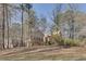 Exterior view of the home featuring mature trees, landscaping, and an American flag at 2731 Tritt Springs Ne Dr, Marietta, GA 30062