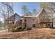 Charming home boasts large windows, a balcony, and a lush yard, blending architectural beauty with natural surroundings at 2731 Tritt Springs Ne Dr, Marietta, GA 30062