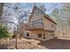 Unique architectural style home featuring a balcony, geometric windows, and neutral siding, nestled amongst mature trees at 2731 Tritt Springs Ne Dr, Marietta, GA 30062