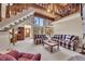 Bright living room featuring a stone fireplace, beamed ceiling, and an open staircase at 2731 Tritt Springs Ne Dr, Marietta, GA 30062
