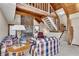 Inviting living room with a stone fireplace, beamed ceiling, and staircase leading to a loft area at 2731 Tritt Springs Ne Dr, Marietta, GA 30062