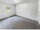 Clean bedroom with gray carpet, white walls and trim, and a bright window at 3783 Red Rose Ct, Loganville, GA 30052