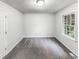 Bright bedroom with neutral carpet, textured ceiling, and natural light from the window at 3783 Red Rose Ct, Loganville, GA 30052