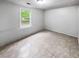 This bedroom features tile floors, a window and neutral color scheme at 3783 Red Rose Ct, Loganville, GA 30052