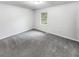 Cozy bedroom with neutral carpet, a window and fresh, white walls at 3783 Red Rose Ct, Loganville, GA 30052
