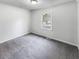 Relaxing bedroom featuring gray carpet, a window, and white-painted walls at 3783 Red Rose Ct, Loganville, GA 30052