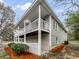Charming home with white siding, a spacious walkout deck, and a lush landscaped yard at 3783 Red Rose Ct, Loganville, GA 30052