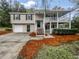 Inviting split-level home with a covered porch and well-manicured landscaping at 3783 Red Rose Ct, Loganville, GA 30052