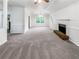 Open-concept living room featuring neutral carpet, classic fireplace, and stylish lighting at 3783 Red Rose Ct, Loganville, GA 30052