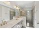 Bathroom featuring a double sink vanity with updated lighting, frameless shower and fixtures at 264 Castleberry Station Sw Dr, Atlanta, GA 30313