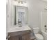 Bathroom with modern vanity, sink, toilet, and shower-tub combo at 264 Castleberry Station Sw Dr, Atlanta, GA 30313