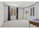 Sunlit bedroom with neutral carpet, windows, and curtains at 264 Castleberry Station Sw Dr, Atlanta, GA 30313