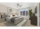Bedroom featuring a ceiling fan, large window and neutral décor with modern gray and tan accents at 264 Castleberry Station Sw Dr, Atlanta, GA 30313
