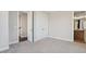 Carpeted bedroom with closet and an adjacent bathroom, offering a peaceful retreat at 264 Castleberry Station Sw Dr, Atlanta, GA 30313