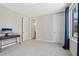 Bright bedroom featuring neutral carpet, baseboards, and closet doors at 264 Castleberry Station Sw Dr, Atlanta, GA 30313