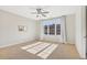Spacious bedroom featuring a large window, neutral carpet, and a ceiling fan at 264 Castleberry Station Sw Dr, Atlanta, GA 30313