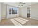 Bedroom featuring carpet, a ceiling fan, a large window and an en-suite bathroom at 264 Castleberry Station Sw Dr, Atlanta, GA 30313