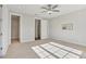 Bedroom featuring neutral carpet, a ceiling fan, a large window and an en-suite bathroom at 264 Castleberry Station Sw Dr, Atlanta, GA 30313