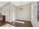Cozy dining area with elegant light fixture, hardwood floors, and natural lighting at 264 Castleberry Station Sw Dr, Atlanta, GA 30313
