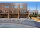 Rear exterior view of townhomes with patios, garages, and sturdy brick construction at 264 Castleberry Station Sw Dr, Atlanta, GA 30313