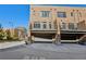 View of attached garages with metal balconies and brick exterior at 264 Castleberry Station Sw Dr, Atlanta, GA 30313