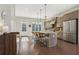 Open kitchen featuring a large island with seating, stainless steel appliances, and modern design at 264 Castleberry Station Sw Dr, Atlanta, GA 30313