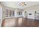 Bright living room features hardwood floors, large windows, and modern ceiling fan at 264 Castleberry Station Sw Dr, Atlanta, GA 30313