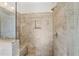 Modern bathroom shower with frameless glass, bench, and neutral-toned tile at 264 Castleberry Station Sw Dr, Atlanta, GA 30313