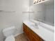 Bathroom featuring a wood vanity, white countertop, sink, and a large mirror at 328 Village Ln, Stockbridge, GA 30281