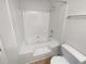 Bathroom featuring a white tub, shower, toilet, and towel bar at 328 Village Ln, Stockbridge, GA 30281